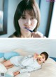 A woman brushing her teeth while laying on a bed.