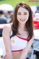 A woman in a red and white bikini posing for a picture.