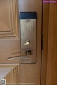 A close up of a door handle on a wooden door.