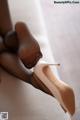 A close up of a woman's feet wearing high heels.