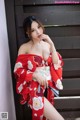 a woman in a red kimono posing for the camera